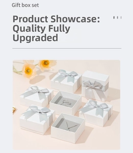 Elegant white jewelry gift box set with silver bows and decorative orange poppy flowers