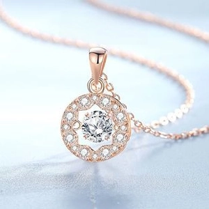 Macro shot of S925 silver necklace with dancing zircon pendant in rose gold finish
