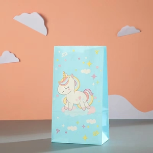Close-up of light blue paper gift bag with cartoon unicorn and star patterns for parties