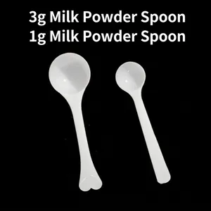 White plastic 1g and 3g measuring scoops for milk powder with heart shaped handles