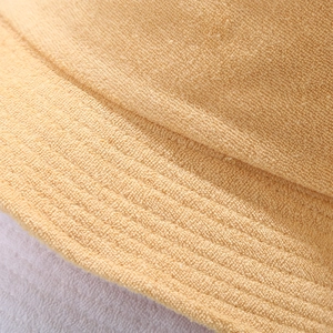 Macro shot of camel terry cloth fabric showing soft texture and fine stitching detail