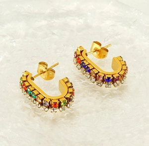 Close-up of gold-plated U-shaped earrings with colorful pave-set rhinestones