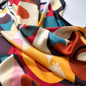 Close-up of colorful floral print silk scarf with fine texture and smooth glossy finish