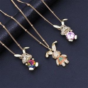 Three gold rabbit necklaces with colorful cubic zirconia pendants on black leather