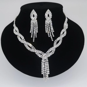 Silver bridal jewelry set with sparkling rhinestones on black velvet display stand
