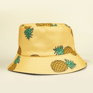 Bright yellow bucket hat with tropical pineapple patterns for sun protection and travel