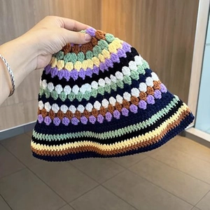 Close-up of the colorful handmade crochet texture and striped patterns on the wool hat