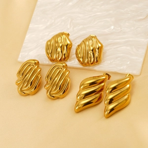 Macro detail of three pairs of 18K gold-plated irregular geometric stainless steel earrings