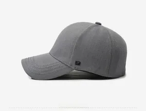Side view detail of grey cotton baseball cap with square logo and stitched brim