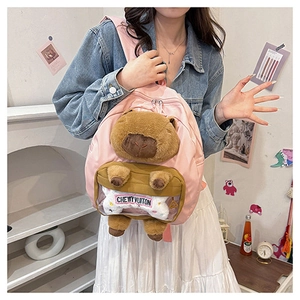 Detailed plush Capybara face on a pink nylon backpack with a cute bone accessory