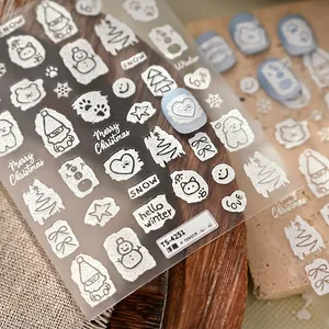 3D embossed Christmas nail stickers featuring white snowman and snowflake patterns