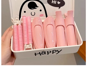 Portable white storage box with pink hair volume clips and velcro rollers set