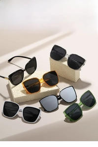 Detailed close-up of multiple colored square oversized sunglasses on stone props