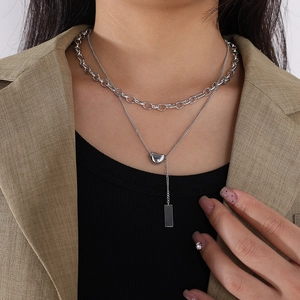 Double-layer stainless steel necklace featuring silver bean and bar pendants for women