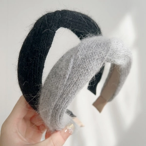 Detail showing plush knitted headband texture in black and grey for autumn winter
