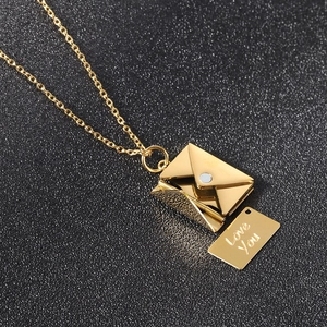 Detailed shot of golden stainless steel envelope pendant with Love You engraved insert