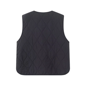 Detail of black quilted vest featuring elegant wave stitching and high-quality fabric texture