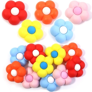 Detailed view of colorful PVC 3D flower charms for rubber beach bags in multiple colors