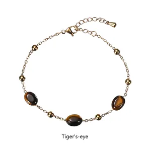 Detailed macro view of the gold chain tiger's eye bracelet with an adjustable tail chain