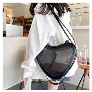 Japanese heart-shaped black ITA bag with clear PVC window shown in lifestyle setting