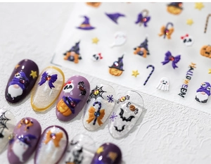 Detailed macro view of 3D embossed Halloween nail stickers with pumpkin and ghost motifs