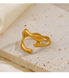 Close-up of irregular 18K gold plated ring on stone base with cream silk fabric detail
