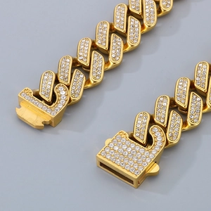 Close-up of gold-plated cuban chain links and square clasp set with sparkling crystals