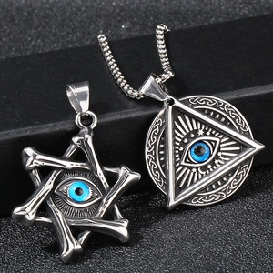 Detail of silver stainless steel hexagram and triangle pendants with blue evil eyes