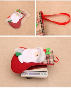 Detail view of small Santa plush Christmas stocking showing hanging loop and 18g weight