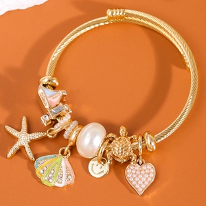Gold stainless steel charm bracelet with starfish, shell, pearl and heart pendants