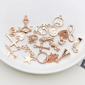 Macro shot of rose gold alloy charms including anchors and crowns for DIY jewelry making