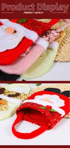 Detailed view of sequin Christmas gift bags with cartoon Santa and reindeer designs