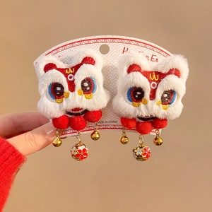 Detail of traditional Chinese lion hair clips with plush texture and golden bells