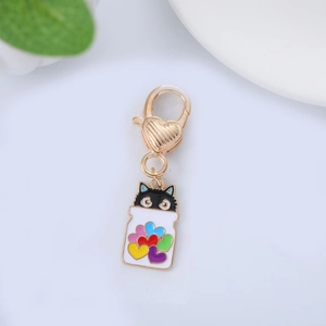 Detailed macro view of a cartoon black cat pendant with colorful heart-shaped drip oil charm