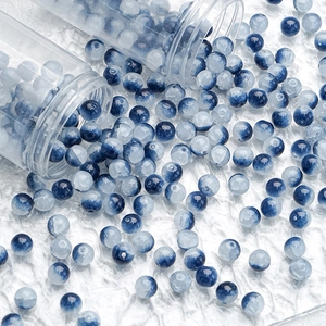 Macro shot of 10mm blue and white gradient glass beads with ice crackle texture