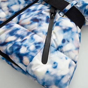 Detailed macro view of waterproof zipper and marble print fabric on ski jacket