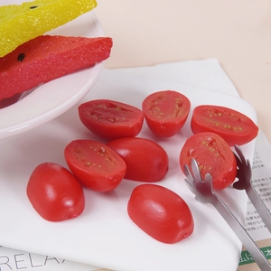 Realistic artificial cherry tomato and watermelon slices set on a display tray