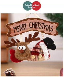 Detail of Christmas reindeer fabric pendant with wood Merry Christmas sign and red heart