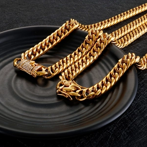 Golden titanium steel Cuban chain necklace with iced out clasp on black tray