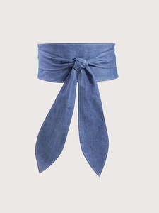 Detail of blue denim waist corset belt featuring contrast white stitching and bow tie