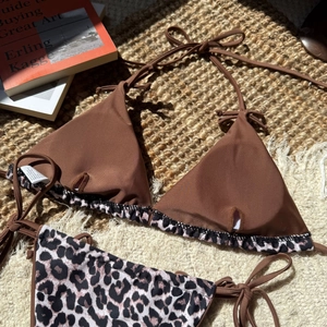 Close-up of leopard print bikini set with lace-up ties and smooth elastic fabric