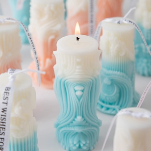 Artistic Roman column scented candle with blue and pink gradients and ribbon