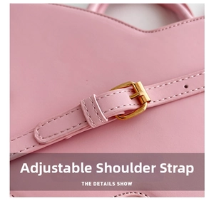 Detail view of pink leather adjustable shoulder strap with premium gold metal buckle