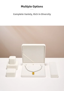 Detailed view of elegant white velvet jewelry boxes with a premium yellow gemstone necklace