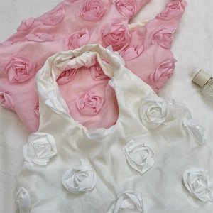 Detailed view of satin tote bag with 3D handmade rose petals in pink and white