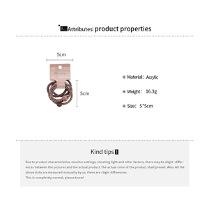Detail view of acrylic spiral hair ties with beads on brand packaging, 5x5cm size