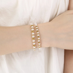 Elegant pearl and gold bead stainless steel bracelet set on a female model wrist