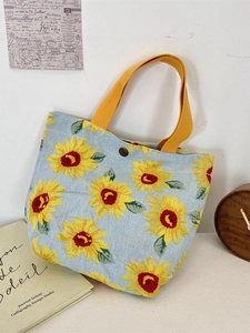Light blue canvas tote bag with yellow sunflower pattern and top handles