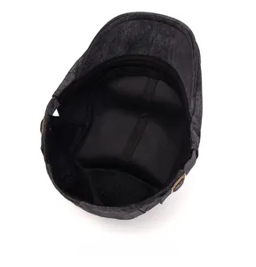 Detail of vintage flat cap interior featuring black lining and adjustable metal buckle
