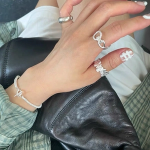 Set of 925 sterling silver braided twist rings and bracelet worn in a stylish casual look